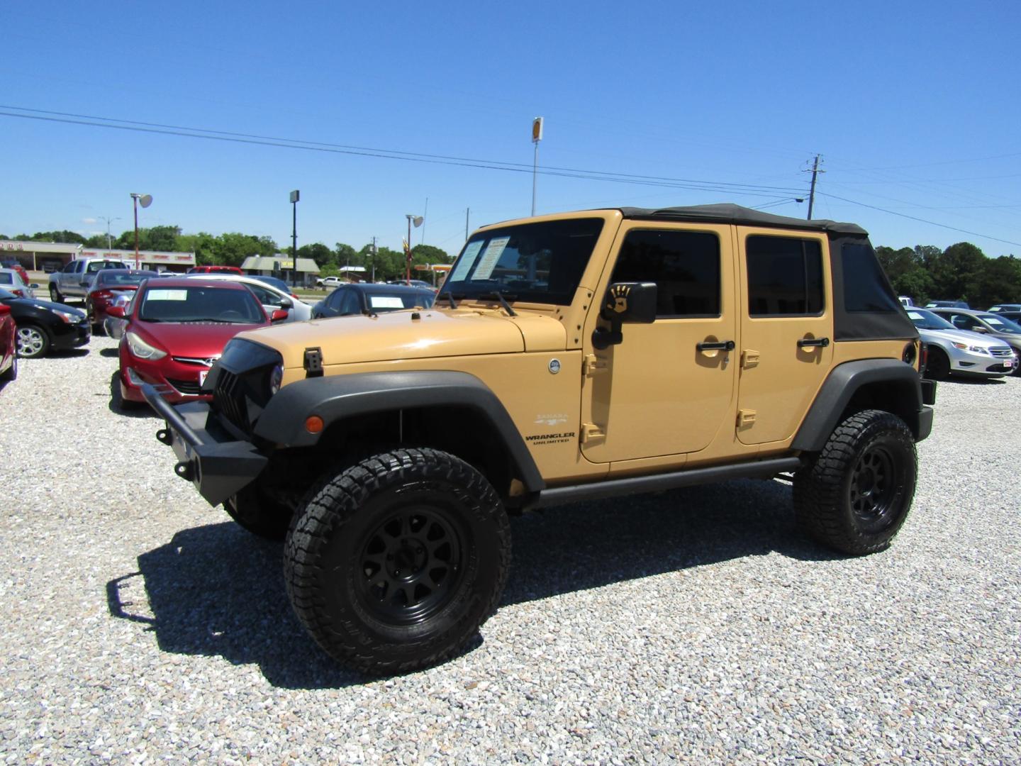 2013 Tan /Black Jeep Wrangler Unlimited Sahara 4WD (1C4HJWEG7DL) with an 3.6L V6 DOHC 24V FFV engine, Automatic transmission, located at 15016 S Hwy 231, Midland City, AL, 36350, (334) 983-3001, 31.306210, -85.495277 - Photo#2